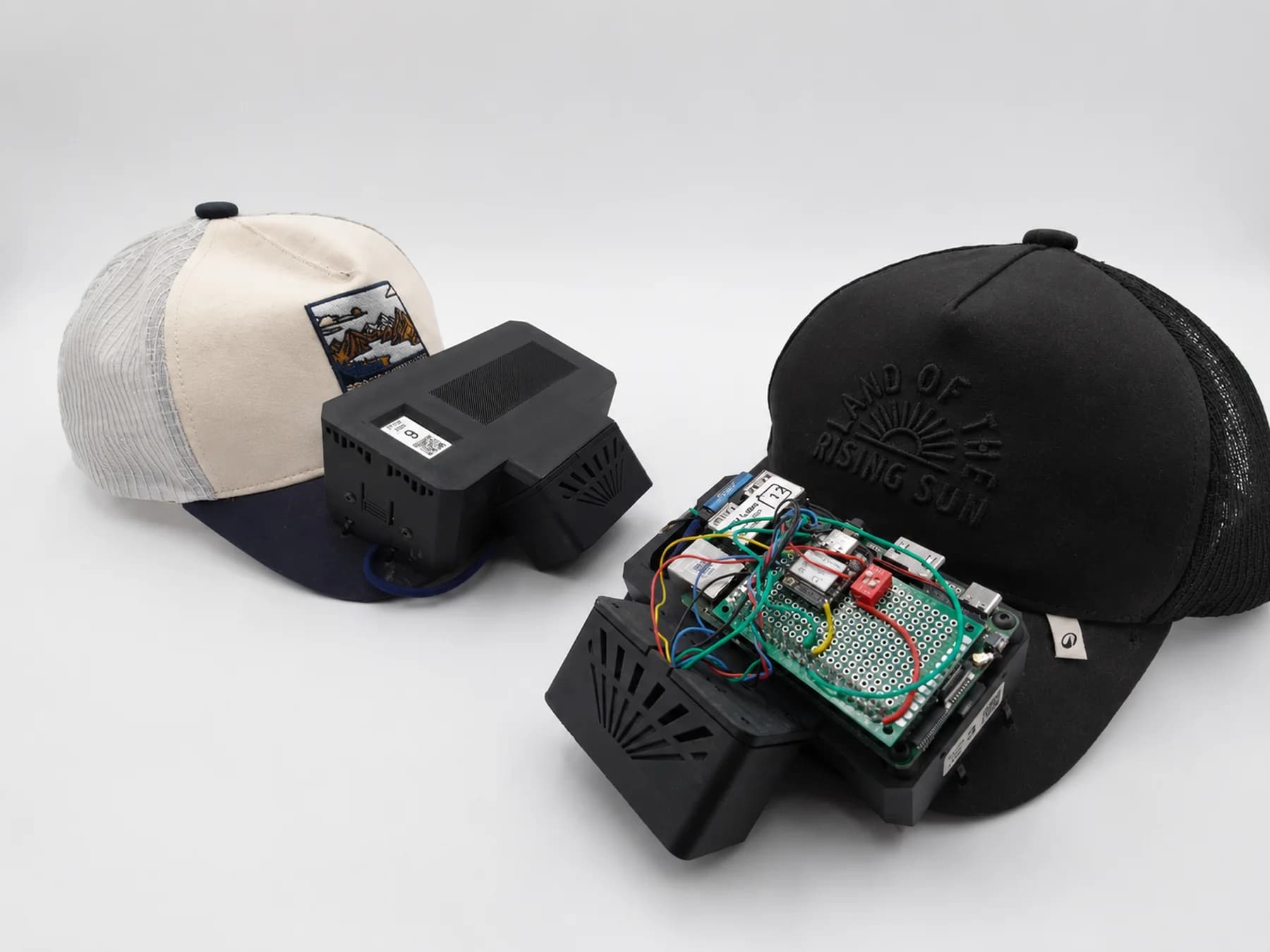 Two assembled Ego-OSCAR caps: a finished unit with a printed enclosure and a development unit with its board exposed